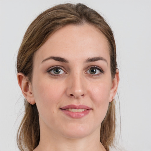 Joyful white young-adult female with medium  brown hair and grey eyes