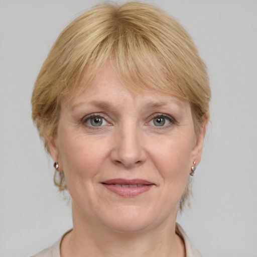 Joyful white adult female with medium  brown hair and grey eyes