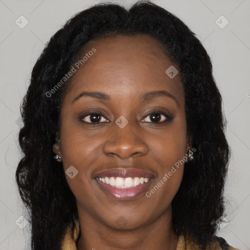 Joyful black young-adult female with long  brown hair and brown eyes