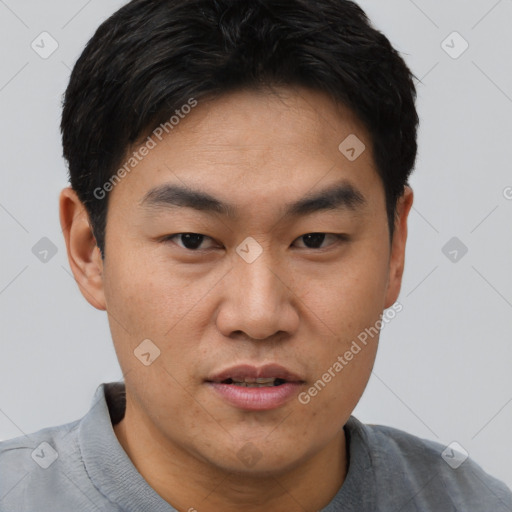 Joyful asian young-adult male with short  black hair and brown eyes
