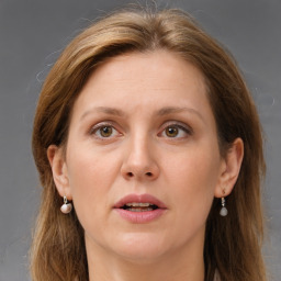 Joyful white adult female with long  brown hair and grey eyes