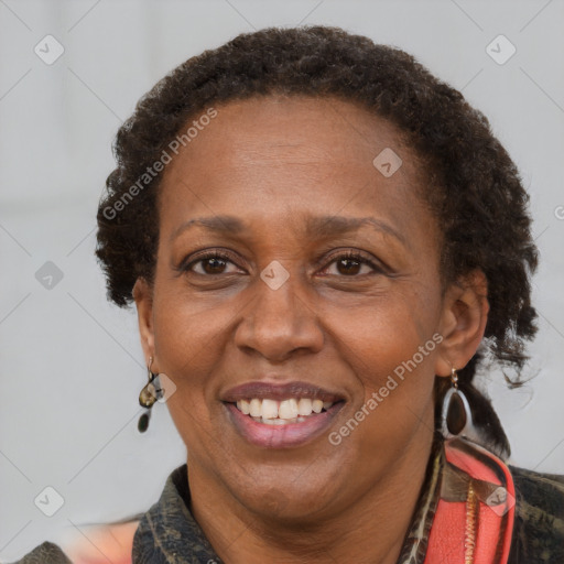 Joyful black adult female with medium  brown hair and brown eyes