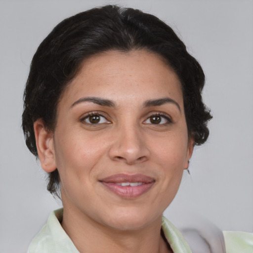 Joyful white adult female with medium  brown hair and brown eyes