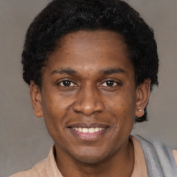 Joyful black young-adult male with short  brown hair and brown eyes
