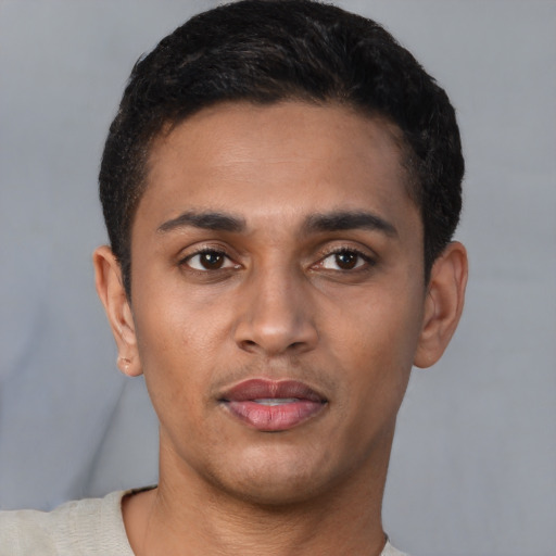 Joyful latino young-adult male with short  brown hair and brown eyes