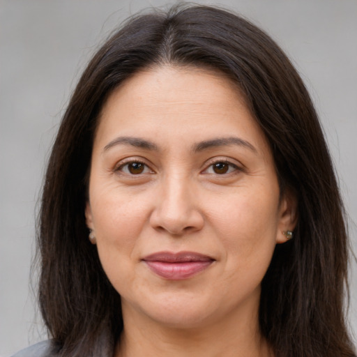 Joyful white adult female with long  brown hair and brown eyes