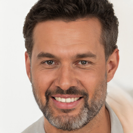 Joyful white adult male with short  brown hair and brown eyes