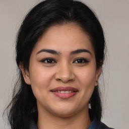 Joyful latino young-adult female with medium  brown hair and brown eyes