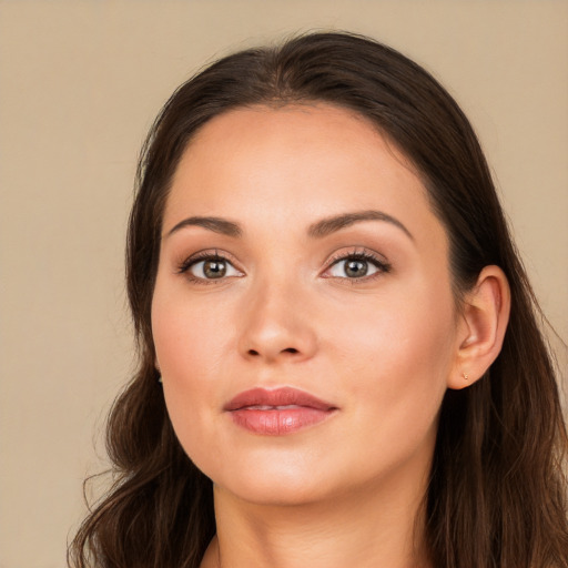 Joyful white young-adult female with long  brown hair and brown eyes