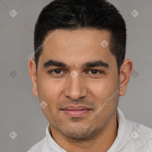 Joyful white young-adult male with short  black hair and brown eyes