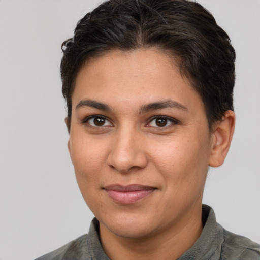 Joyful latino young-adult female with short  brown hair and brown eyes