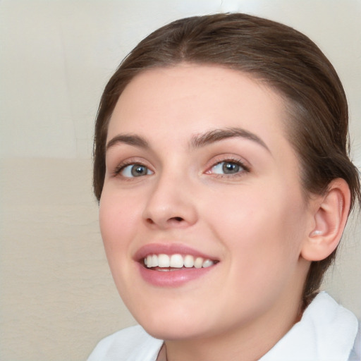 Joyful white young-adult female with medium  brown hair and green eyes