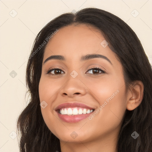 Joyful latino young-adult female with long  brown hair and brown eyes