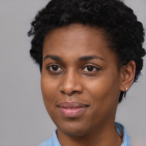 Joyful black young-adult female with short  black hair and brown eyes