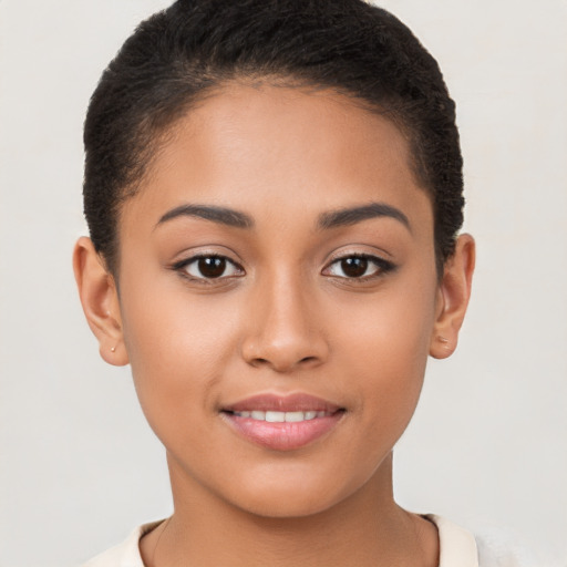 Joyful latino young-adult female with short  brown hair and brown eyes