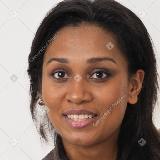 Joyful black young-adult female with long  brown hair and brown eyes