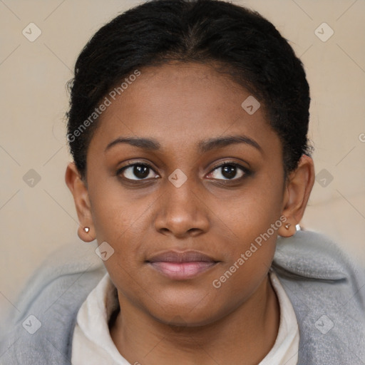 Joyful black young-adult female with short  brown hair and brown eyes