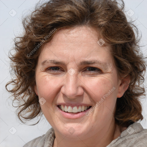 Joyful white adult female with medium  brown hair and blue eyes