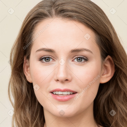 Joyful white young-adult female with long  brown hair and blue eyes