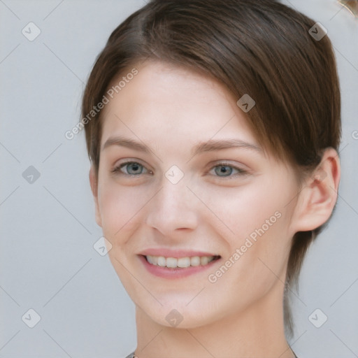 Joyful white young-adult female with medium  brown hair and grey eyes