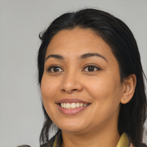 Joyful latino young-adult female with medium  brown hair and brown eyes