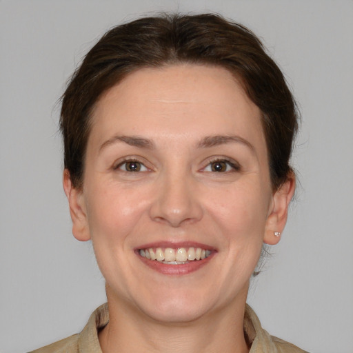 Joyful white young-adult female with medium  brown hair and brown eyes