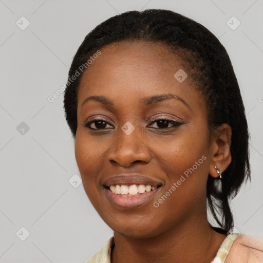 Joyful black young-adult female with long  black hair and brown eyes