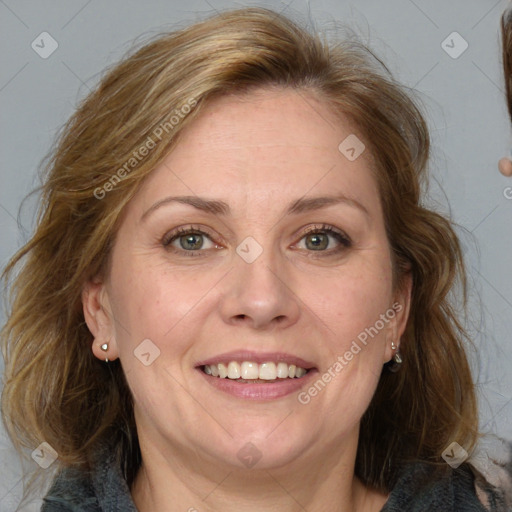 Joyful white adult female with medium  brown hair and blue eyes