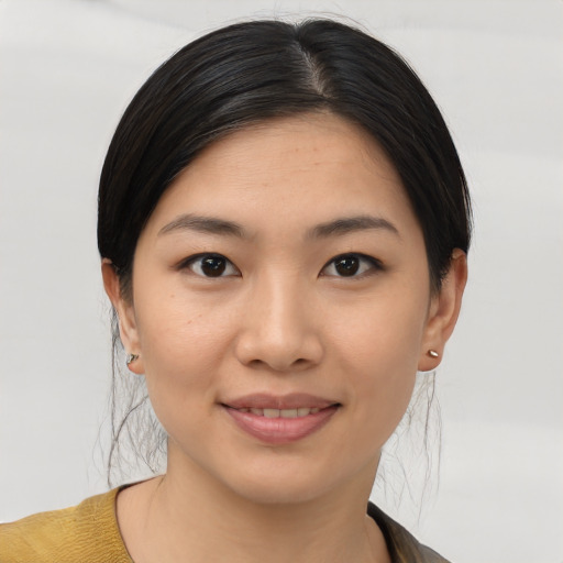 Joyful asian young-adult female with medium  brown hair and brown eyes