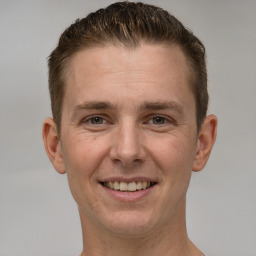 Joyful white adult male with short  brown hair and brown eyes