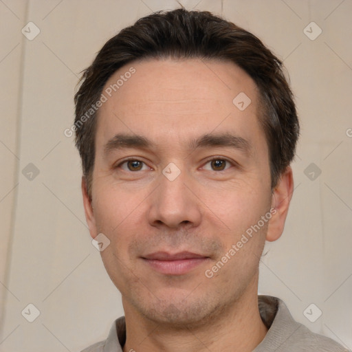 Joyful white adult male with short  black hair and brown eyes