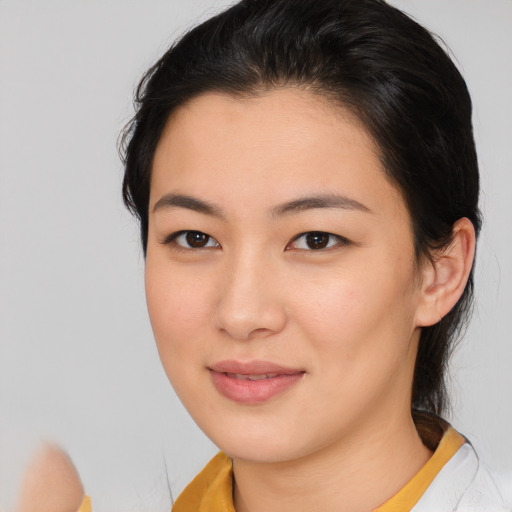Joyful asian young-adult female with medium  brown hair and brown eyes