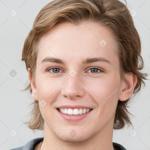 Joyful white young-adult female with medium  brown hair and grey eyes