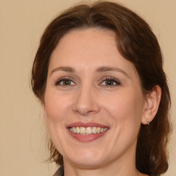 Joyful white adult female with medium  brown hair and brown eyes