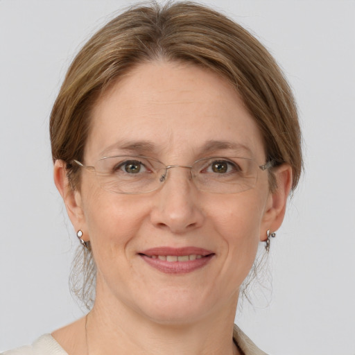 Joyful white adult female with medium  brown hair and grey eyes