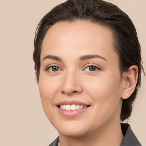 Joyful white young-adult female with medium  brown hair and brown eyes