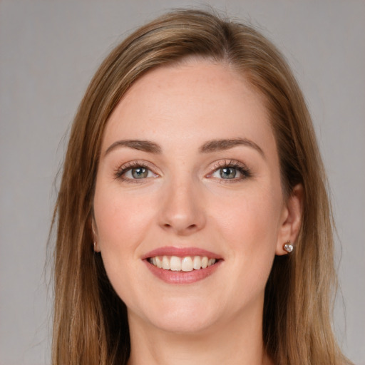 Joyful white young-adult female with long  brown hair and grey eyes