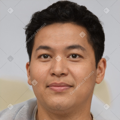 Joyful asian young-adult male with short  brown hair and brown eyes