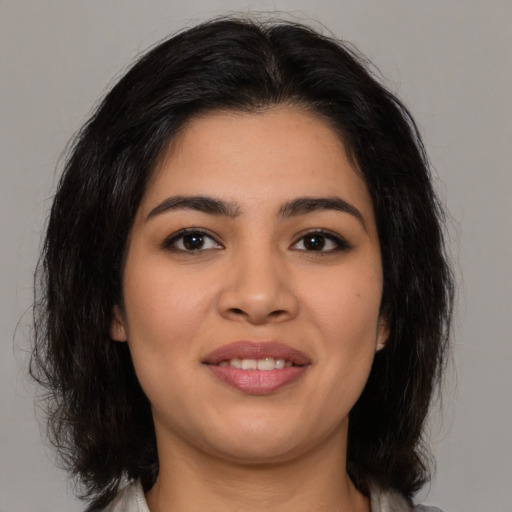 Joyful asian young-adult female with medium  brown hair and brown eyes