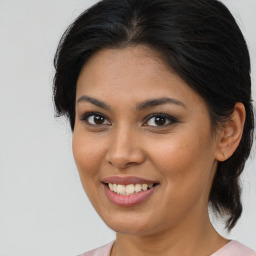 Joyful latino young-adult female with medium  brown hair and brown eyes