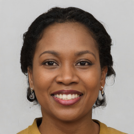 Joyful black young-adult female with medium  brown hair and brown eyes