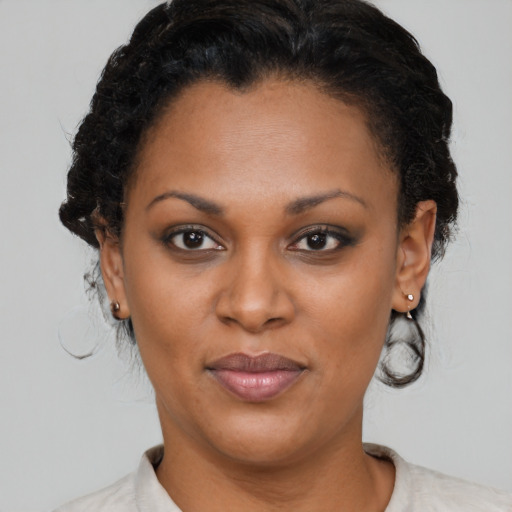 Joyful black adult female with short  brown hair and brown eyes