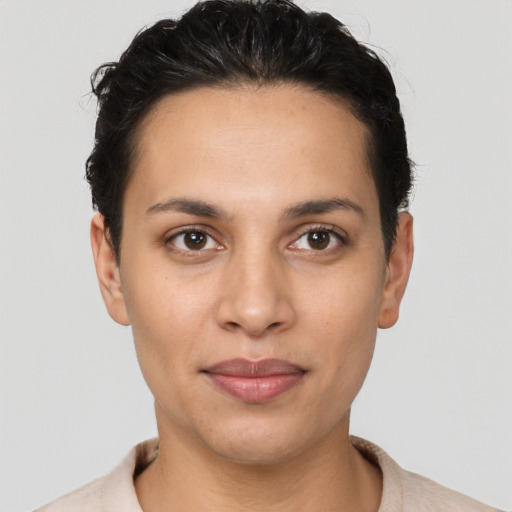 Joyful latino young-adult female with short  brown hair and brown eyes