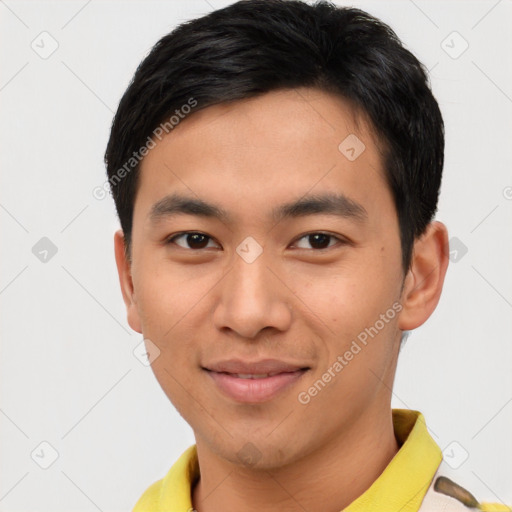 Joyful asian young-adult male with short  black hair and brown eyes
