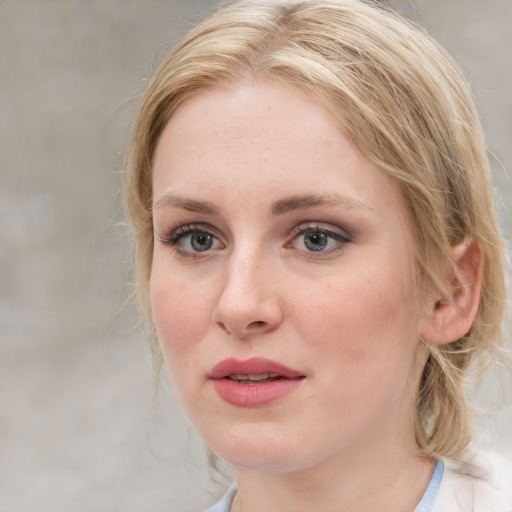 Joyful white young-adult female with medium  brown hair and blue eyes