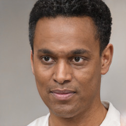 Joyful latino adult male with short  black hair and brown eyes