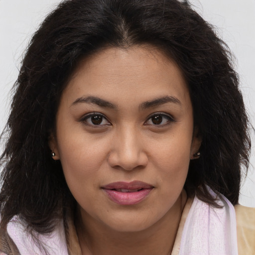 Joyful latino young-adult female with long  brown hair and brown eyes