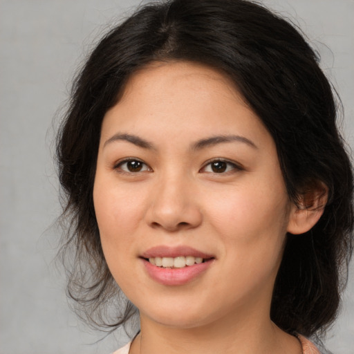 Joyful asian young-adult female with medium  brown hair and brown eyes