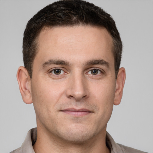 Joyful white young-adult male with short  brown hair and brown eyes