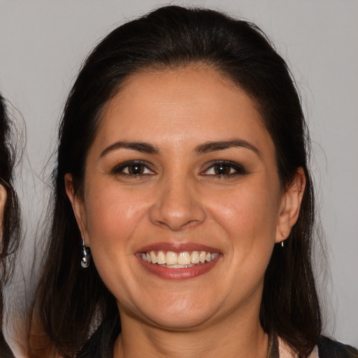 Joyful white adult female with medium  brown hair and brown eyes